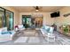 Covered patio with seating area and view into home at 24160 Gallberry Dr, Venice, FL 34293