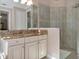 Bathroom with granite countertops, modern vanity, and glass shower at 24160 Gallberry Dr, Venice, FL 34293