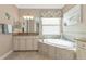 Elegant bathroom with a large soaking tub and granite countertops at 24160 Gallberry Dr, Venice, FL 34293