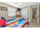 Guest bedroom with wood furniture and access to a hallway at 24160 Gallberry Dr, Venice, FL 34293