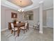 Formal dining room with a wooden table, six chairs, and decorative rug at 24160 Gallberry Dr, Venice, FL 34293