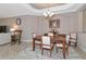 Dining room with a wooden table, six chairs, and a decorative rug at 24160 Gallberry Dr, Venice, FL 34293