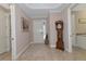 Spacious foyer with hardwood floors, a grandfather clock, and access to other rooms at 24160 Gallberry Dr, Venice, FL 34293