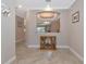 A hallway with tile flooring and a display cabinet at 24160 Gallberry Dr, Venice, FL 34293