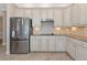 Kitchen with stainless steel refrigerator and white cabinets at 24160 Gallberry Dr, Venice, FL 34293