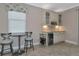 Kitchen features a breakfast bar, wine cooler, and white cabinets at 24160 Gallberry Dr, Venice, FL 34293