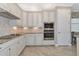 Kitchen with white cabinets, granite countertops, and stainless steel appliances at 24160 Gallberry Dr, Venice, FL 34293