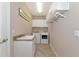 Laundry room with washer, dryer, and cabinets at 24160 Gallberry Dr, Venice, FL 34293