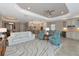 Spacious living room with light colored sofa and two teal accent chairs at 24160 Gallberry Dr, Venice, FL 34293