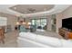 Living room with a white couch, two blue armchairs, and sliding doors leading to a patio at 24160 Gallberry Dr, Venice, FL 34293