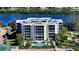 Luxury waterfront building with pool and tennis court at 3240 Gulf Of Mexico Dr # B504, Longboat Key, FL 34228