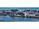 Aerial view of waterfront condo building with tennis courts and pool at 3240 Gulf Of Mexico Dr # B504, Longboat Key, FL 34228
