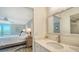Bathroom with single sink vanity and large mirror at 3240 Gulf Of Mexico Dr # B504, Longboat Key, FL 34228