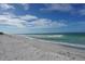 Scenic beach view with blue sky and waves at 3240 Gulf Of Mexico Dr # B504, Longboat Key, FL 34228