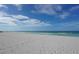 Expansive white sand beach with footprints at 3240 Gulf Of Mexico Dr # B504, Longboat Key, FL 34228