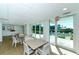 Bright community room with tables, chairs, and pool view at 3240 Gulf Of Mexico Dr # B504, Longboat Key, FL 34228