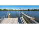 Wooden dock with fishing rod holders at 3240 Gulf Of Mexico Dr # B504, Longboat Key, FL 34228