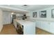 Modern kitchen with white cabinets and large island at 3240 Gulf Of Mexico Dr # B504, Longboat Key, FL 34228