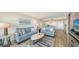 Bright living room with comfy sofas and hardwood floors at 3240 Gulf Of Mexico Dr # B504, Longboat Key, FL 34228