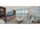 Living room with hardwood floors, sofas, and water views at 3240 Gulf Of Mexico Dr # B504, Longboat Key, FL 34228