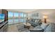 Living room with hardwood floors, comfy sofas, and water views at 3240 Gulf Of Mexico Dr # B504, Longboat Key, FL 34228