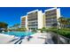 Inviting community pool with plenty of lounge chairs at 3240 Gulf Of Mexico Dr # B504, Longboat Key, FL 34228