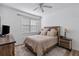 Bedroom with a rustic double bed, nightstand and ceiling fan at 3815 Parkridge Cir # 2-203, Sarasota, FL 34243