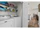 Laundry room with washer, dryer, and shelving at 3815 Parkridge Cir # 2-203, Sarasota, FL 34243