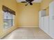 Bedroom with window, ceiling fan and white built-ins at 3841 Albacete Cir # 51, Punta Gorda, FL 33950
