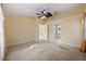 Bright bedroom featuring a ceiling fan and en-suite bathroom access at 3841 Albacete Cir # 51, Punta Gorda, FL 33950