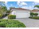 Single villa with white garage door and landscaped walkway at 3841 Albacete Cir # 51, Punta Gorda, FL 33950