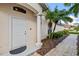 Inviting entryway with white door, columned porch, and landscaped walkway at 3841 Albacete Cir # 51, Punta Gorda, FL 33950