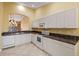 Kitchen with white cabinets, granite countertops, and tiled floors at 3841 Albacete Cir # 51, Punta Gorda, FL 33950