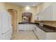 Kitchen with white cabinets, granite counters, and tiled floor at 3841 Albacete Cir # 51, Punta Gorda, FL 33950