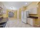 Kitchen with white cabinets, granite countertops and tiled floors at 3841 Albacete Cir # 51, Punta Gorda, FL 33950
