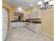 Kitchen with white cabinets, granite counters, and tiled floor at 3841 Albacete Cir # 51, Punta Gorda, FL 33950