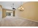 Spacious living room with chandelier, ceiling fan and carpet at 3841 Albacete Cir # 51, Punta Gorda, FL 33950