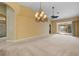 Living room with chandelier, ceiling fan and carpet at 3841 Albacete Cir # 51, Punta Gorda, FL 33950