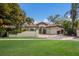Beautiful Mediterranean-style home with lush landscaping, a green lawn and a two-car garage at 4946 Brywill Cir, Sarasota, FL 34234