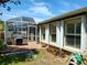 The backyard has a grill, an enclosed porch, and an outdoor table for entertaining at 5115 44Th St W, Bradenton, FL 34210