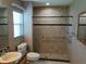 This bathroom features a tiled shower, grab bars, and a granite countertop sink at 5115 44Th St W, Bradenton, FL 34210