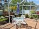 Enjoy an outdoor meal at the table and seating area in the screened in back porch at 5115 44Th St W, Bradenton, FL 34210