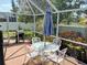 This porch has a grill, table with umbrella, chairs and surrounding landscaping at 5115 44Th St W, Bradenton, FL 34210
