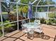 This porch has a table with umbrella, chairs and surrounding landscaping at 5115 44Th St W, Bradenton, FL 34210