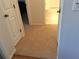 Hallway featuring carpet and doors leading to bedrooms and bathrooms, providing privacy and separation of living spaces at 5115 44Th St W, Bradenton, FL 34210