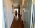 View of the entry hallway with hardwood floors leading into the main living space of the home at 5115 44Th St W, Bradenton, FL 34210