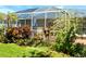 This is an image of a beautiful enclosed patio with lush landscaping all around at 5115 44Th St W, Bradenton, FL 34210