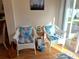 A sun room with wicker chairs and blue accent pillows at 5115 44Th St W, Bradenton, FL 34210