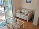 Relaxing sunroom with wicker furniture and access to patio at 5115 44Th St W, Bradenton, FL 34210