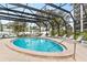 Relaxing pool with a screened enclosure for year-round enjoyment and privacy with several lounge chairs at 512 W Venice Ave # 401, Venice, FL 34285